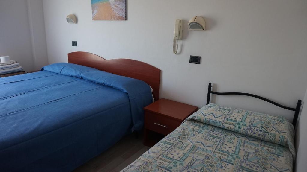 Postel nebo postele na pokoji v ubytování Hotel Daria
