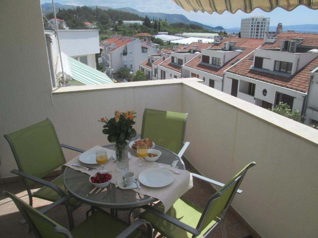 a table and chairs on a balcony with a view at Apartment Lana in Split