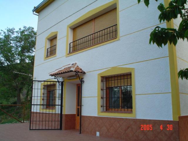 a white building with three windows and a door at Casa Tere in Miller