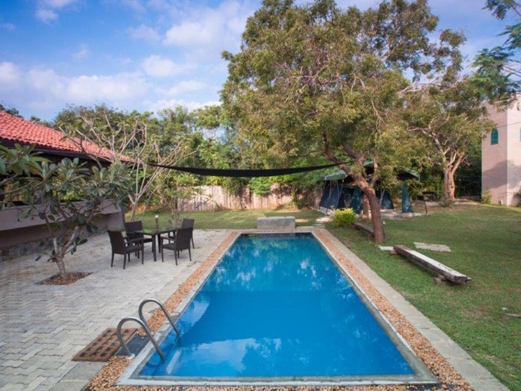 a swimming pool in the backyard of a house at Yala Villa in Yala