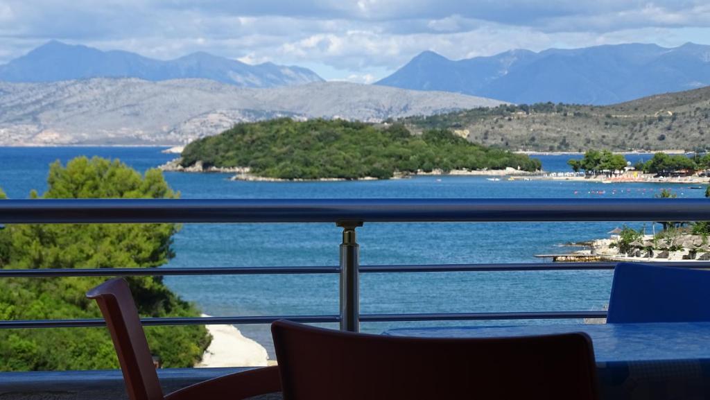a room with a view of the water and mountains at Vila Bilali in Ksamil