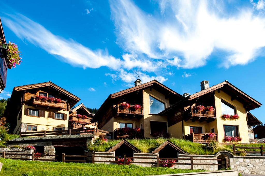 a house with flower boxes on the side of it at Chalet Garden in Livigno
