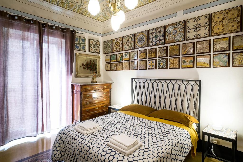 a bedroom with a bed in a room with pictures on the wall at Stanze al Genio B&B in Palermo