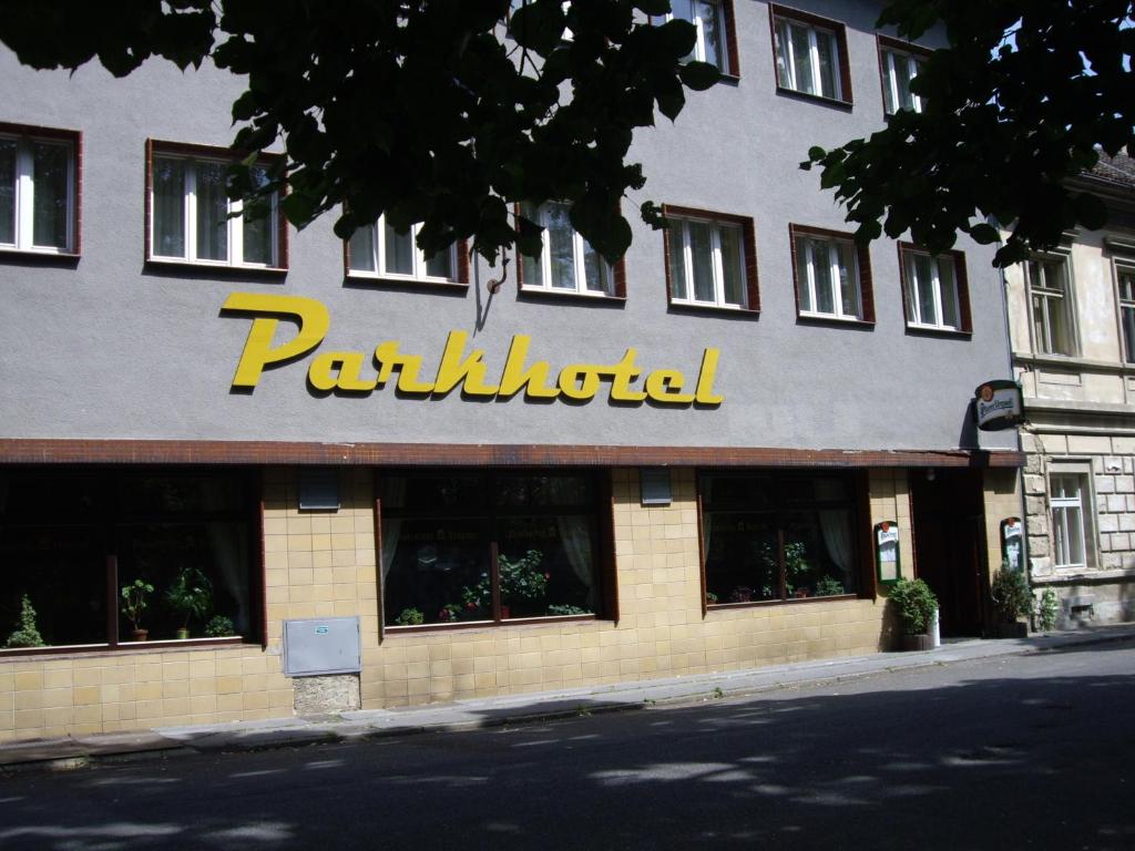 a building with a paulmutilus sign on it at Parkhotel Terezín in Terezín