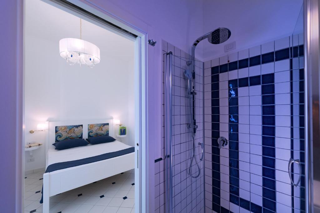 a bathroom with purple walls and a shower with a crib at Vista d'Amalfi in Amalfi