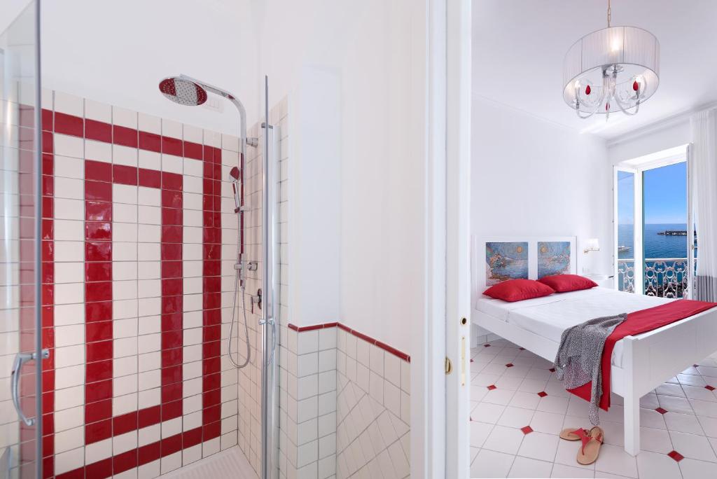 a red and white bathroom with a bed and a shower at Vista d'Amalfi in Amalfi