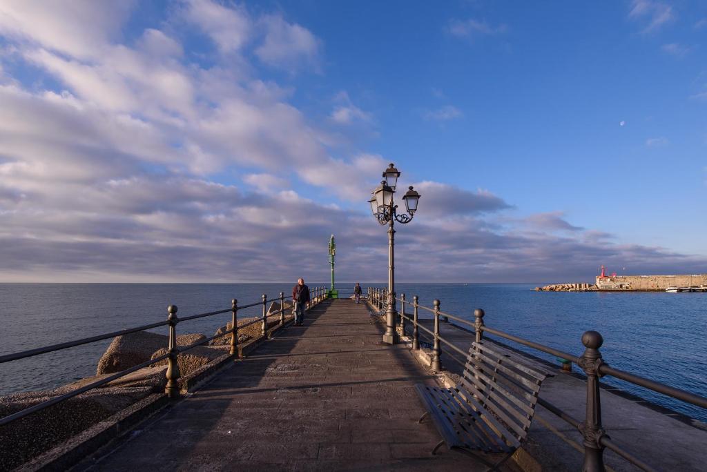 a wooden pier with a light pole and the water at Vista d'Amalfi in Amalfi