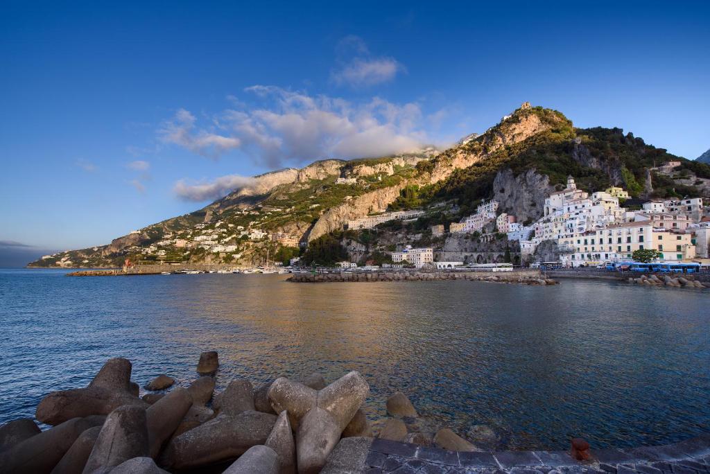 a view of a town on a hill next to the water at Vista d'Amalfi in Amalfi