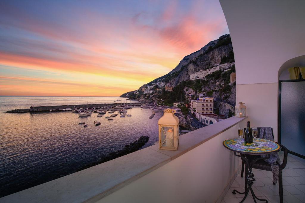 a view of the ocean from a balcony with a sunset at Vista d'Amalfi in Amalfi
