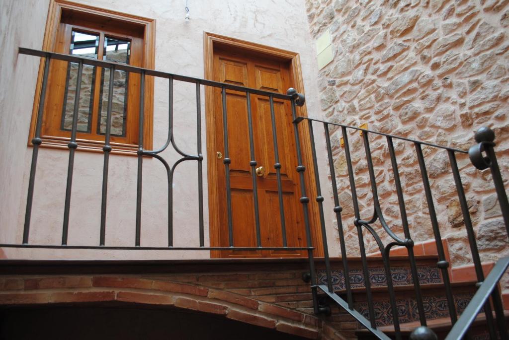 a staircase with a wooden door and a window at Abuelo Duplex in Mora de Rubielos