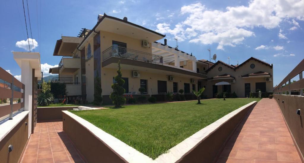 a large house with a lawn in front of it at Palmyra Studios in Stavros