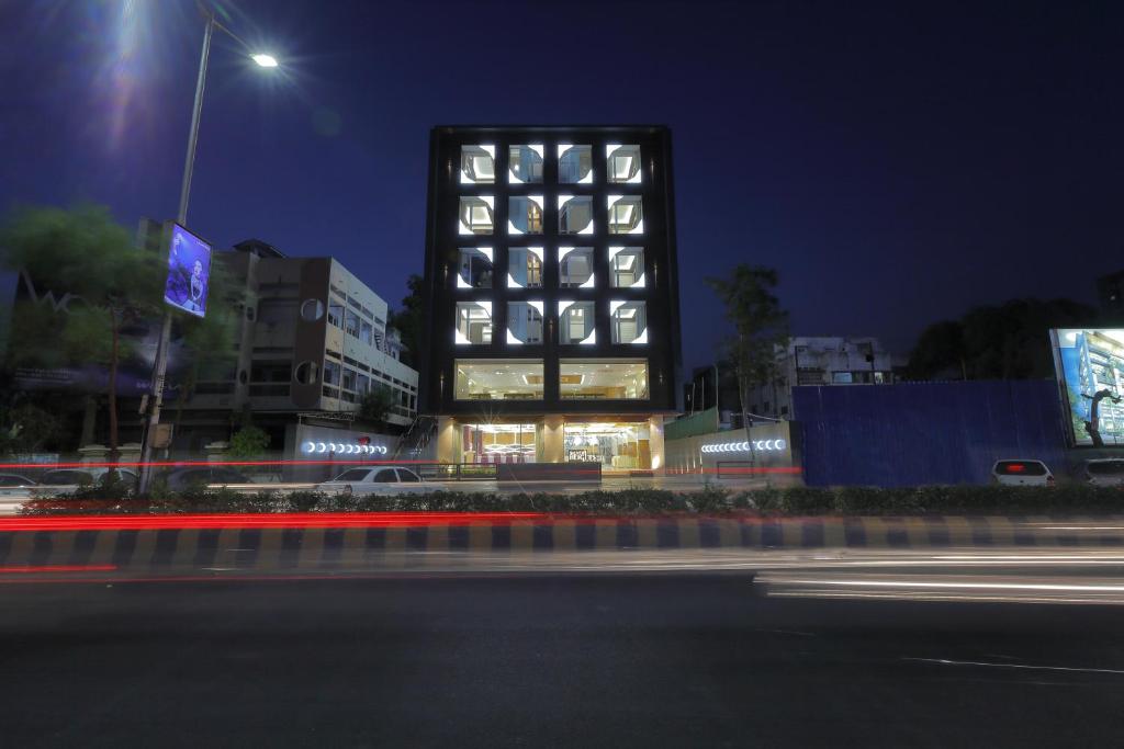 a building with a lot of windows at night at Hotel Silver Heights in Ahmedabad