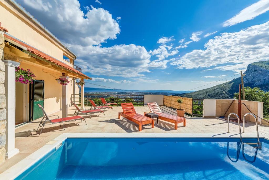 a villa with a swimming pool with a view at Holiday Home Marincello in Solin