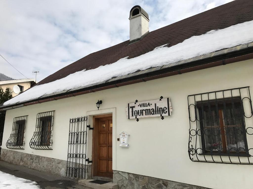 a white building with a sign that reads unit turnaround at Villa Tourmaline in Kremnica
