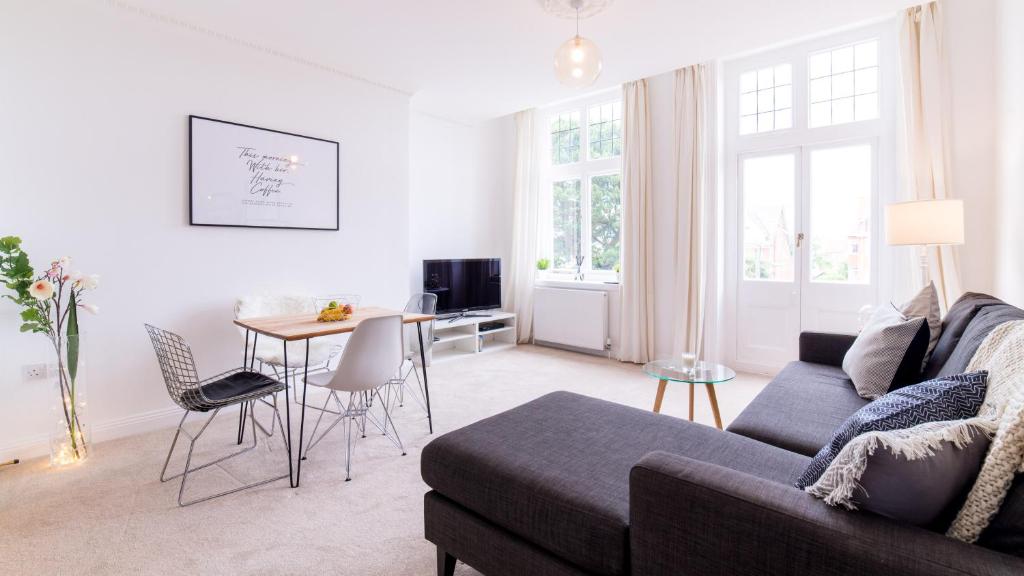 a living room with a couch and a table at Victorian Apartment in Bournemouth