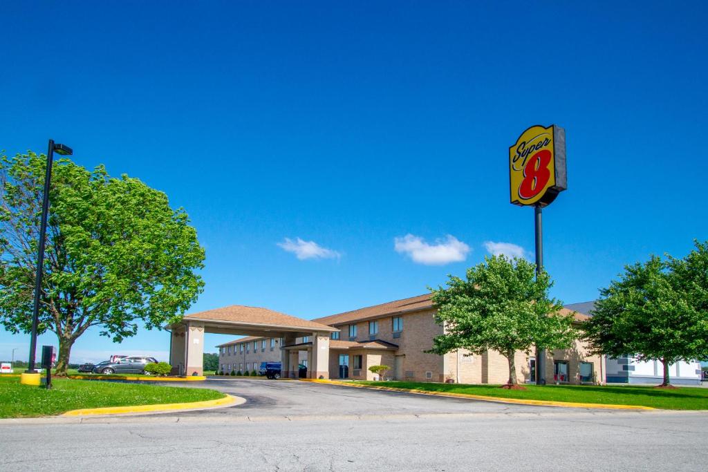 a building with a cola sign in front of it at Super 8 by Wyndham Kokomo in Kokomo