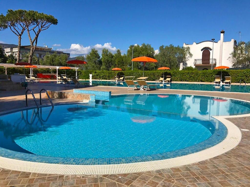 a large swimming pool with blue water at Hotel River Palace in Terracina