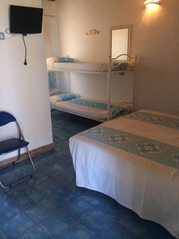 A bed or beds in a room at Agriturismo Irghitula