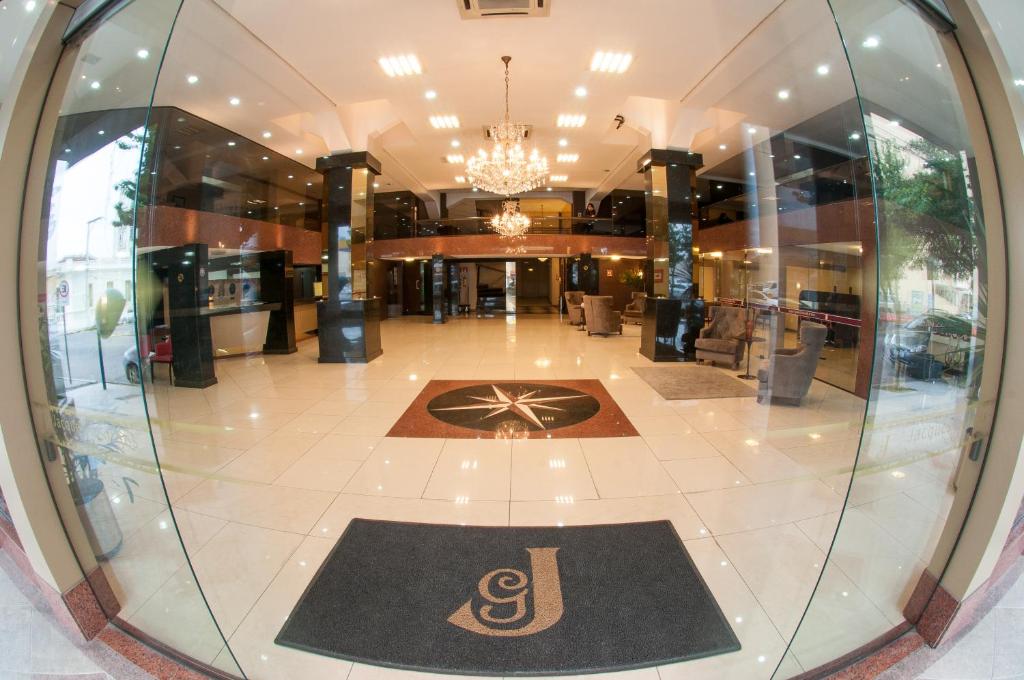 a lobby with a large glass window in a building at Jacques Georges Tower in Pelotas