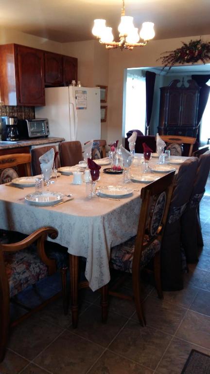 a table with wine glasses on it in a kitchen at Gite Agricole Les Lilas in Saint Wenceslas