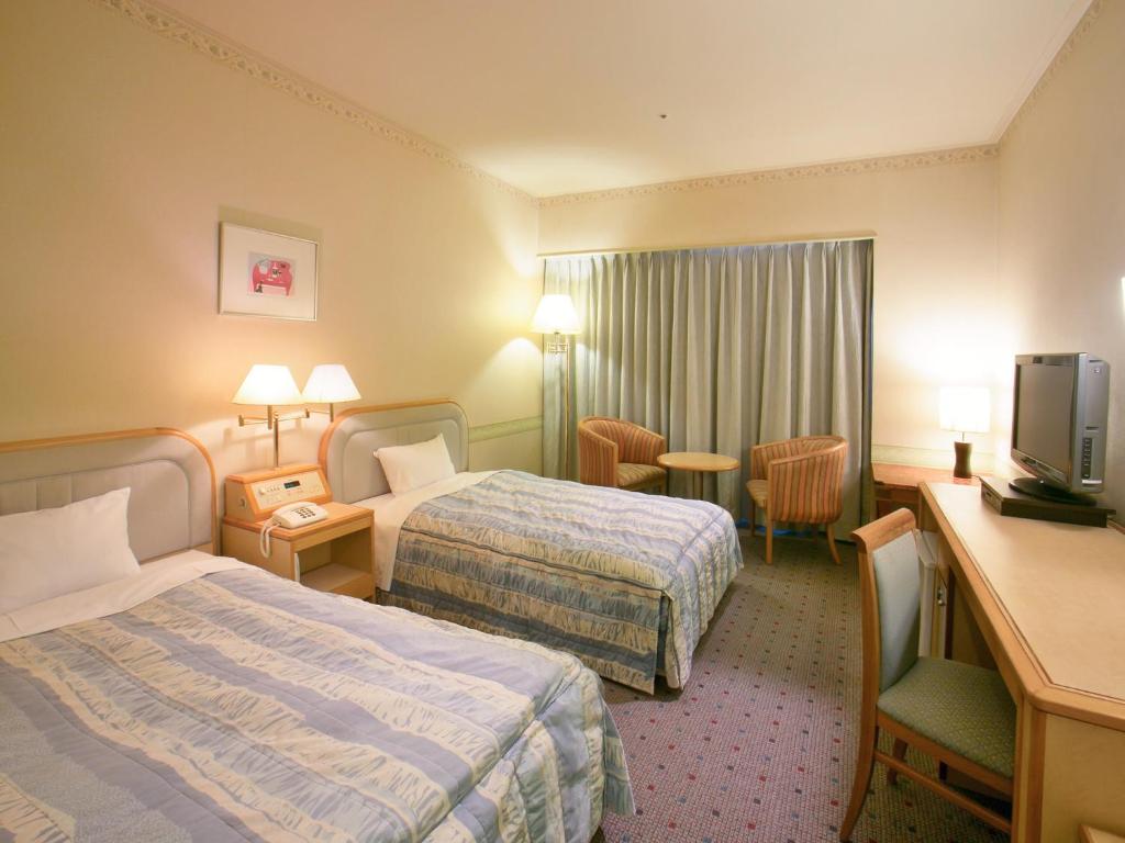 Tempat tidur dalam kamar di Yamagata Nanokamachi Washington Hotel