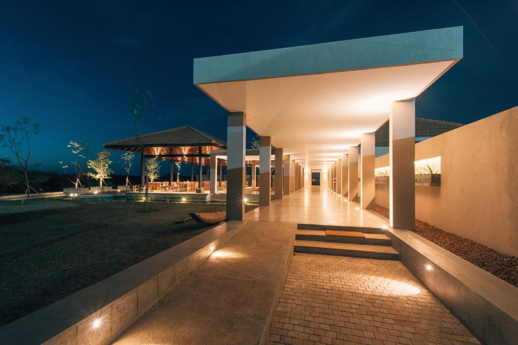a night view of a building with lights at The Palmyrah House in Mannar