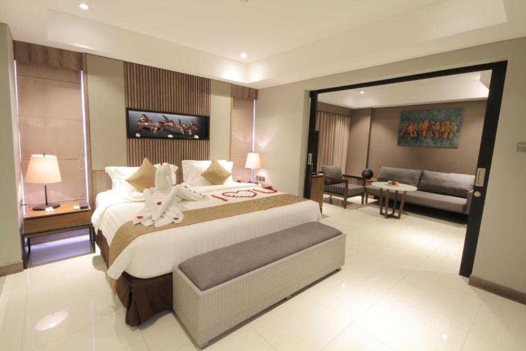 A bed or beds in a room at The Nest Hotel Nusa Dua