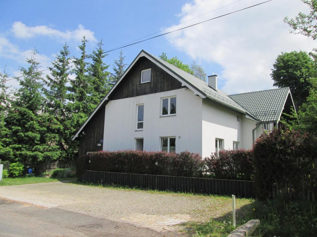 a white house with a black roof at Willawil in Karpacz