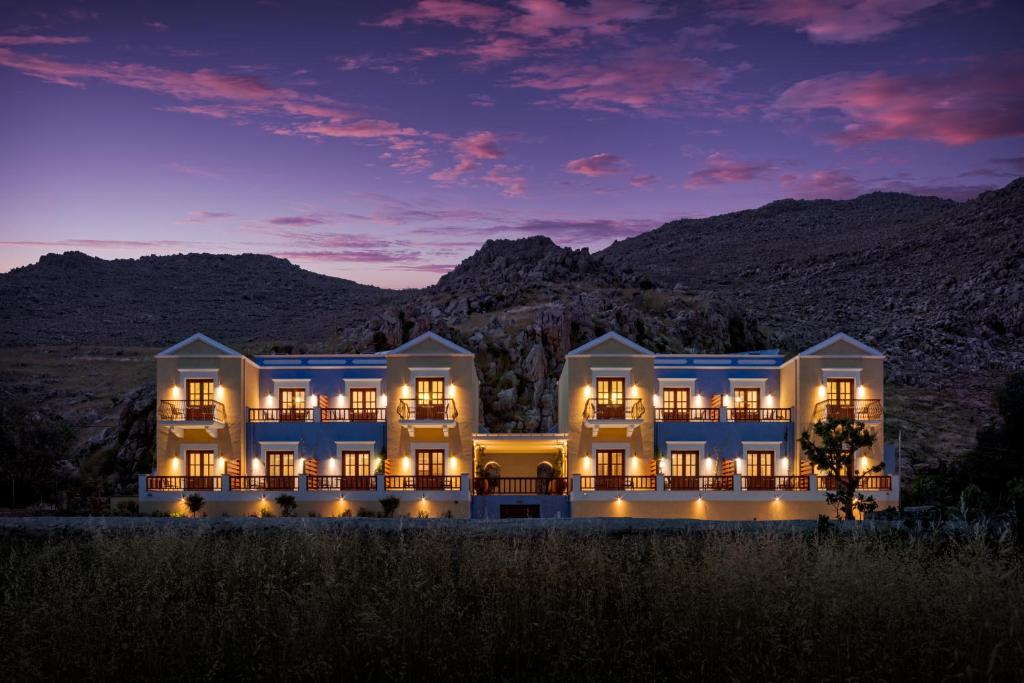 a rendering of a building with mountains in the background at Asymi Residences in Symi