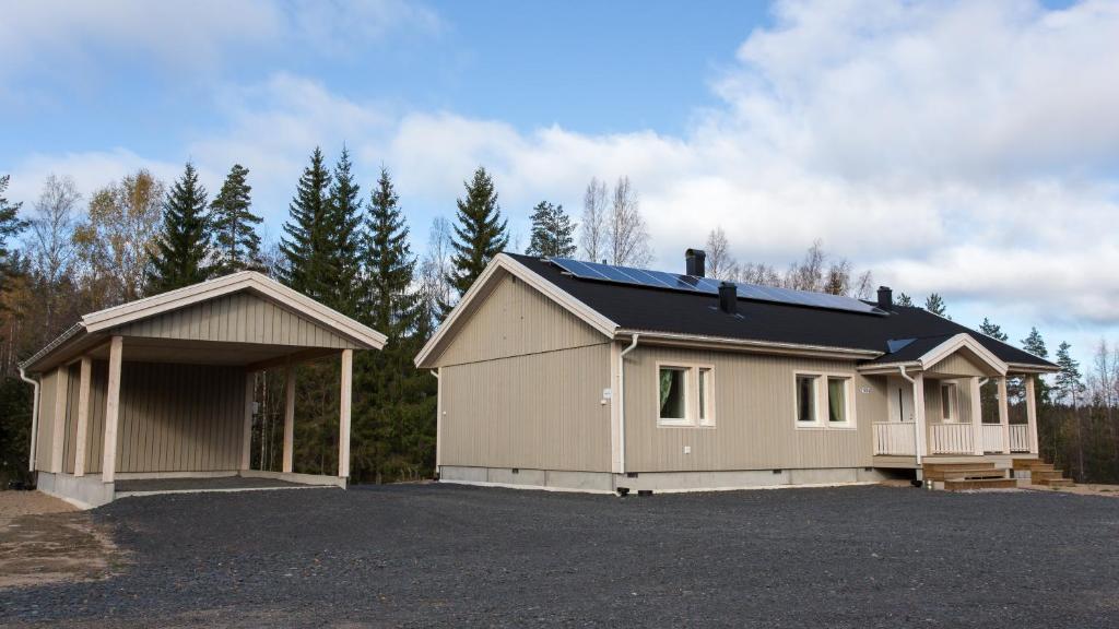 una casa con un garage e un posto auto di Tiinan tupa A a Moksinkylä