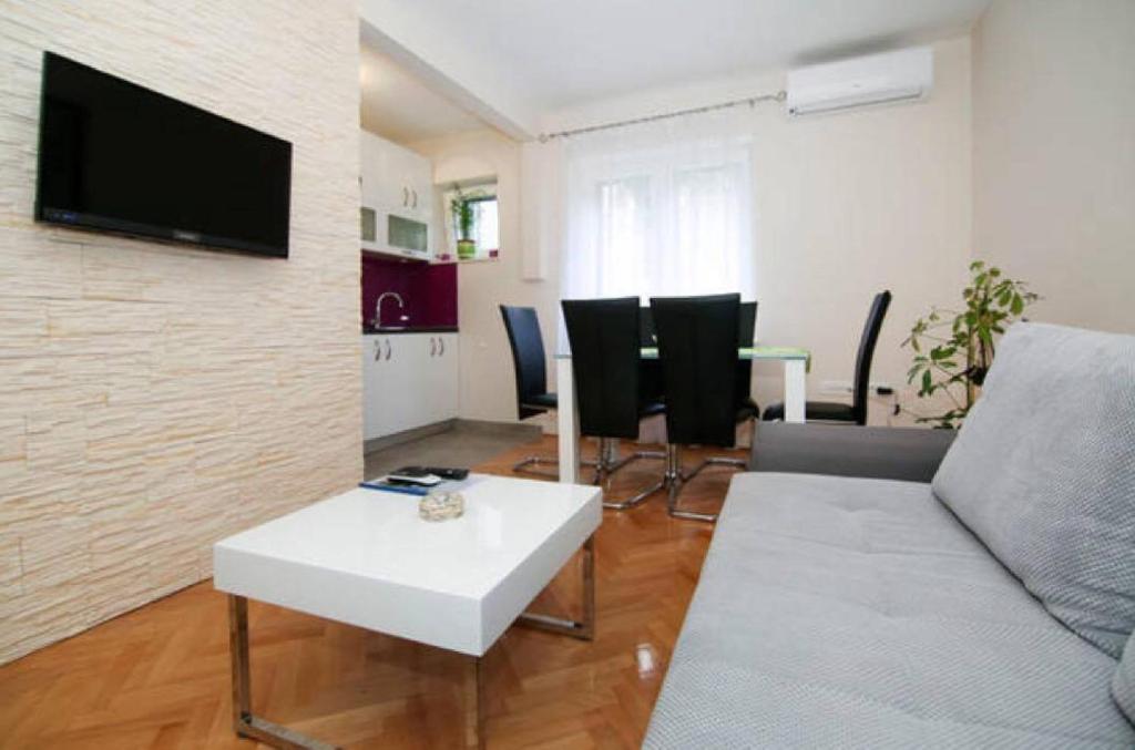 a living room with a couch and a table at Apartment Anđelina in Split