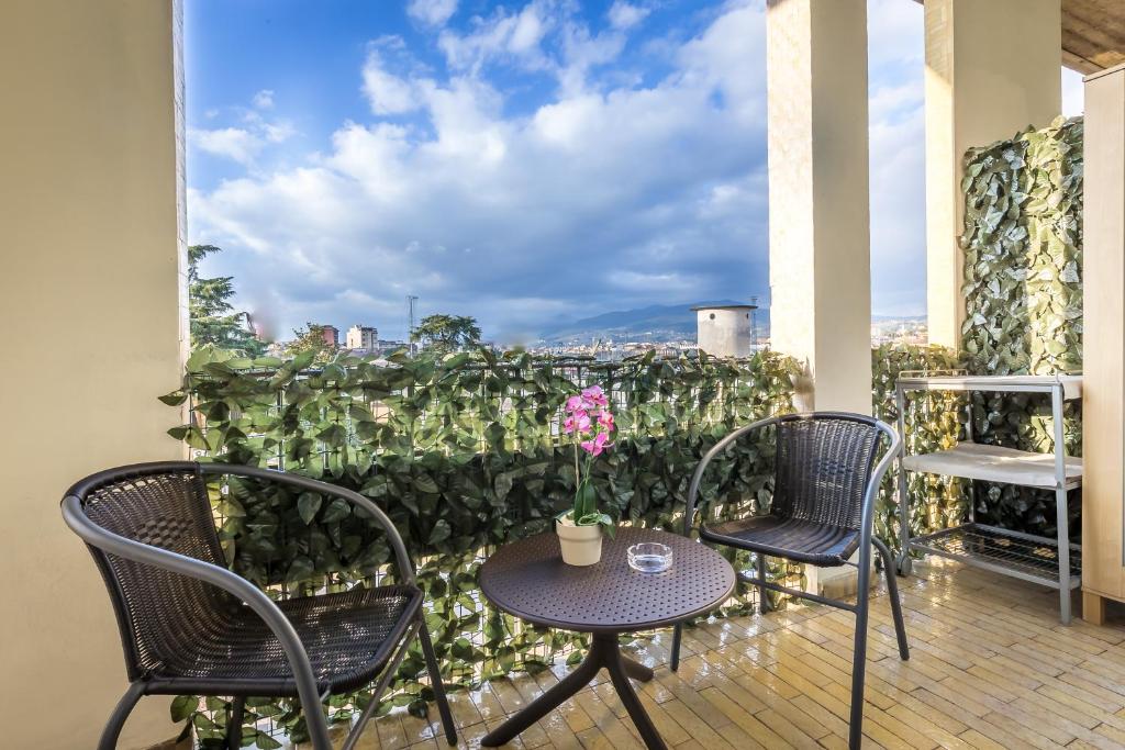 a table and chairs on a balcony with a view at Maison Bianca B&B in Florence