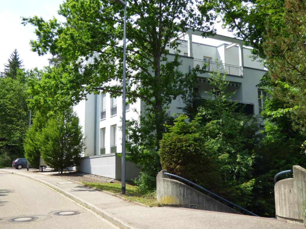 a white building on the side of a street at SeWeR Apartment in Baden-Baden