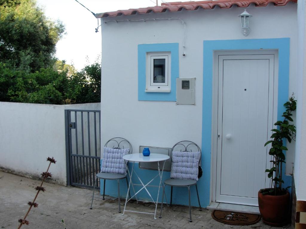 a table and two chairs in front of a building at Manta Rota Holiday Home in Manta Rota