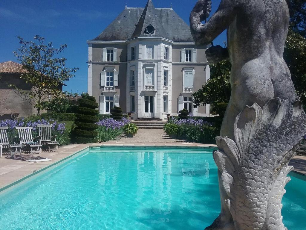 a statue of a mermaid in front of a mansion at Château de Prety - Maison d'Hôtes in Préty