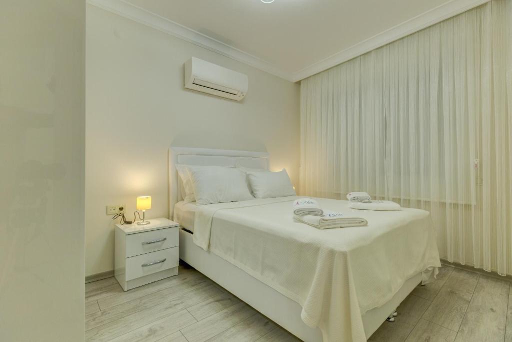 Postel nebo postele na pokoji v ubytování Paris Residence Cesme