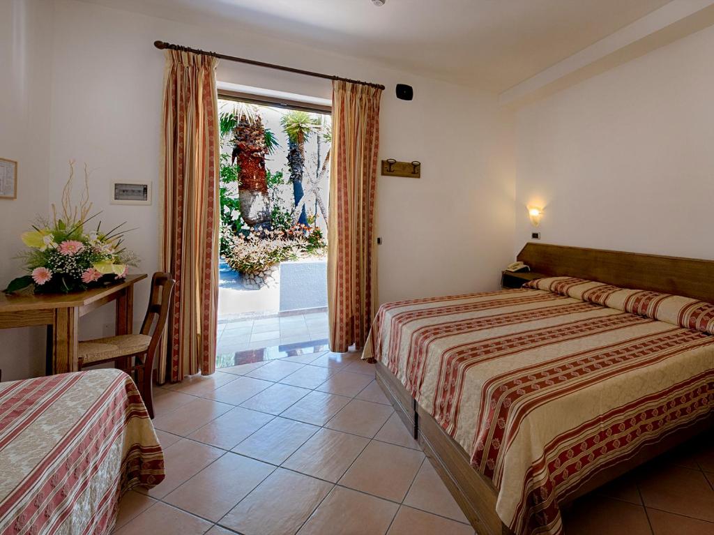 Postel nebo postele na pokoji v ubytování Hotel Villa Miralisa