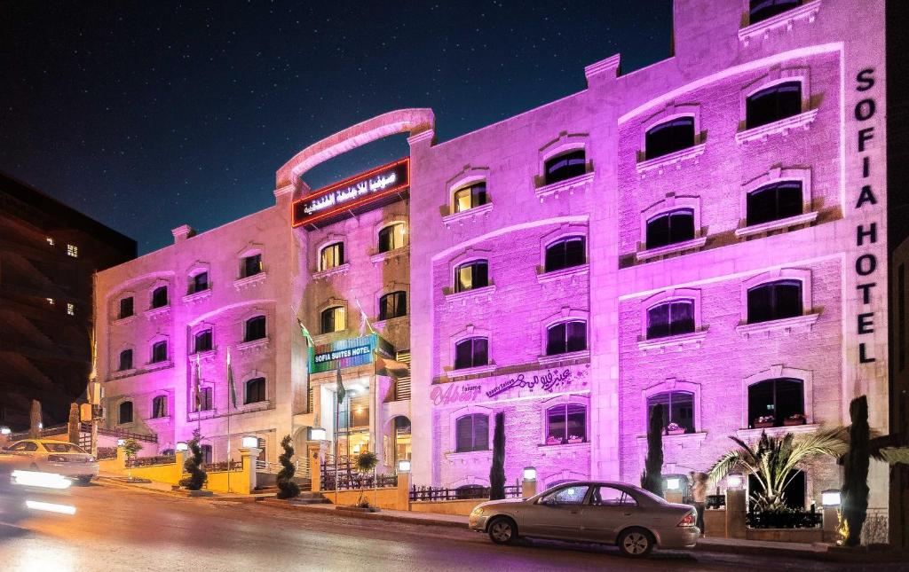 a purple building with a car parked in front of it at Sofia Suites Hotel in Amman