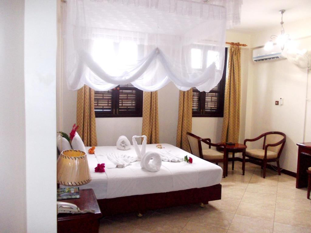 Postel nebo postele na pokoji v ubytování Safari Lodge