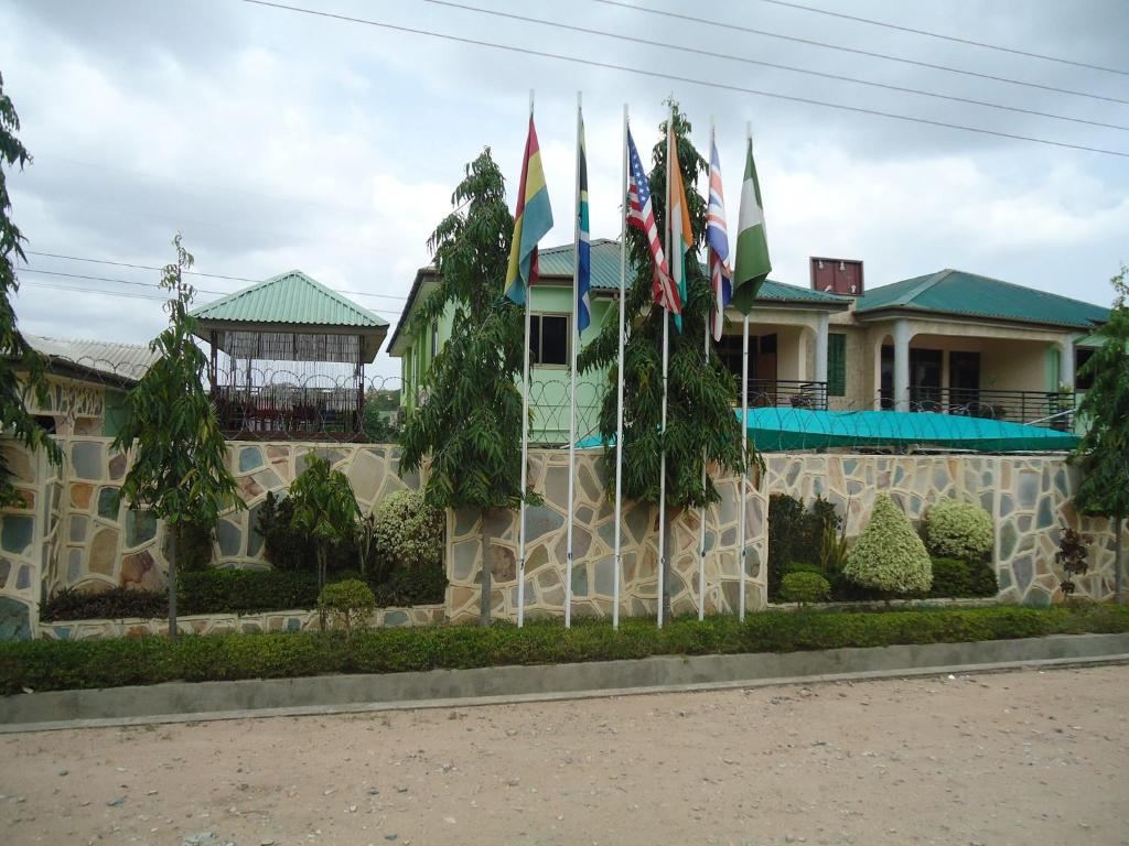 a house with flags in front of it at Dokua Royal Hotel in Accra