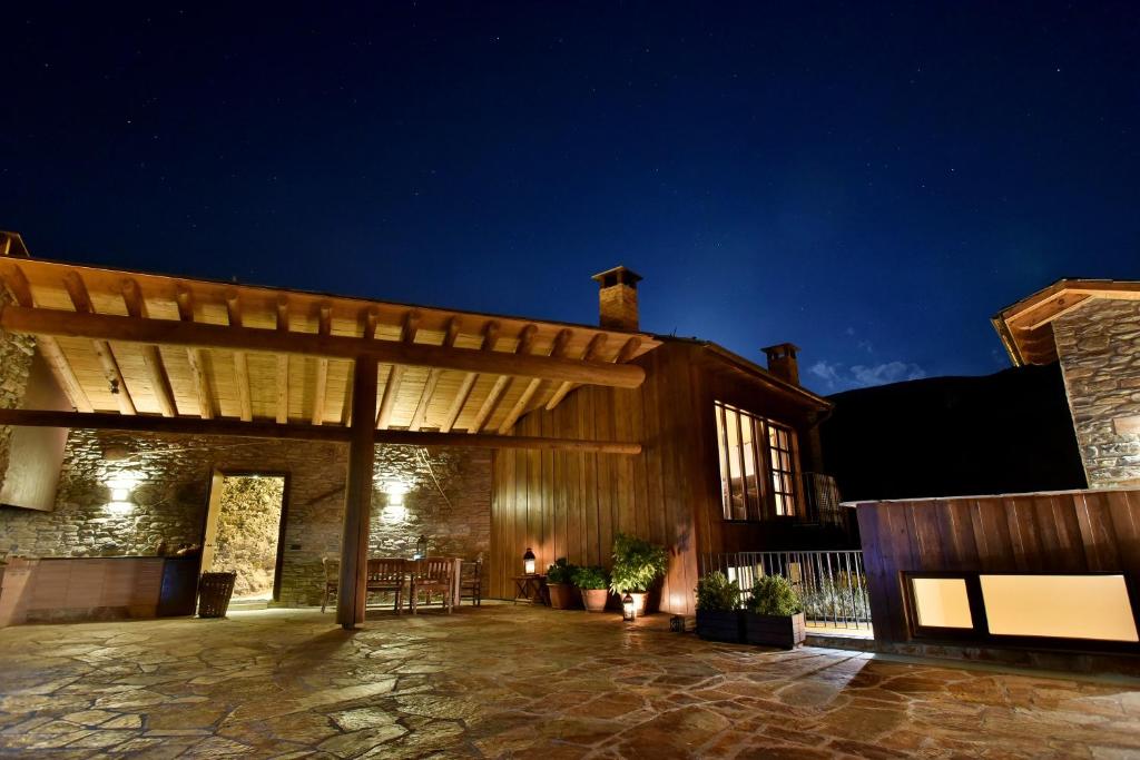 a large building with a patio at night at La Rectoria in Vall de Castellbò