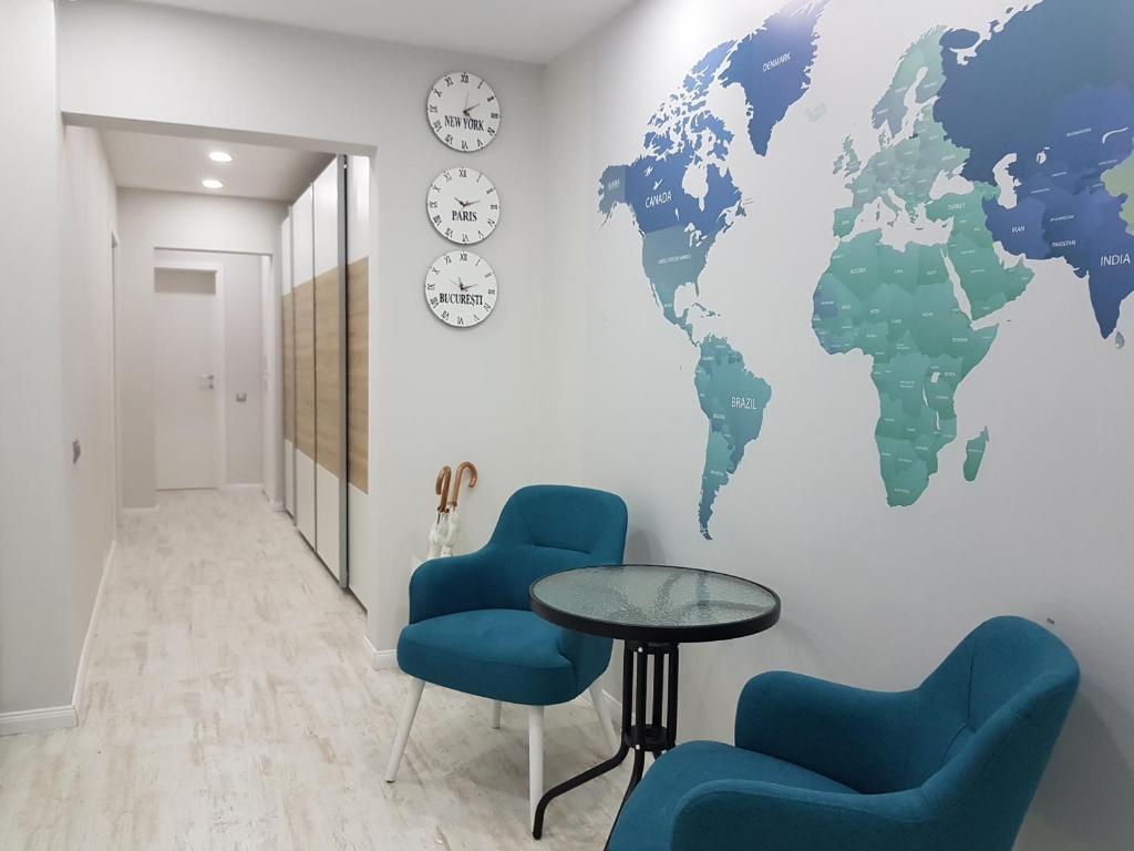 a waiting room with a world map mural on the wall at Apartament Verde in Cluj-Napoca