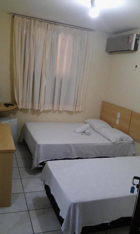 Postel nebo postele na pokoji v ubytování Hotel Sambaquis
