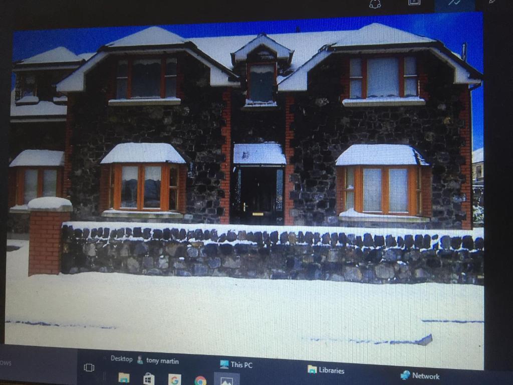 a picture of a house with snow on it at Knightsbrook Guesthouse in Trim