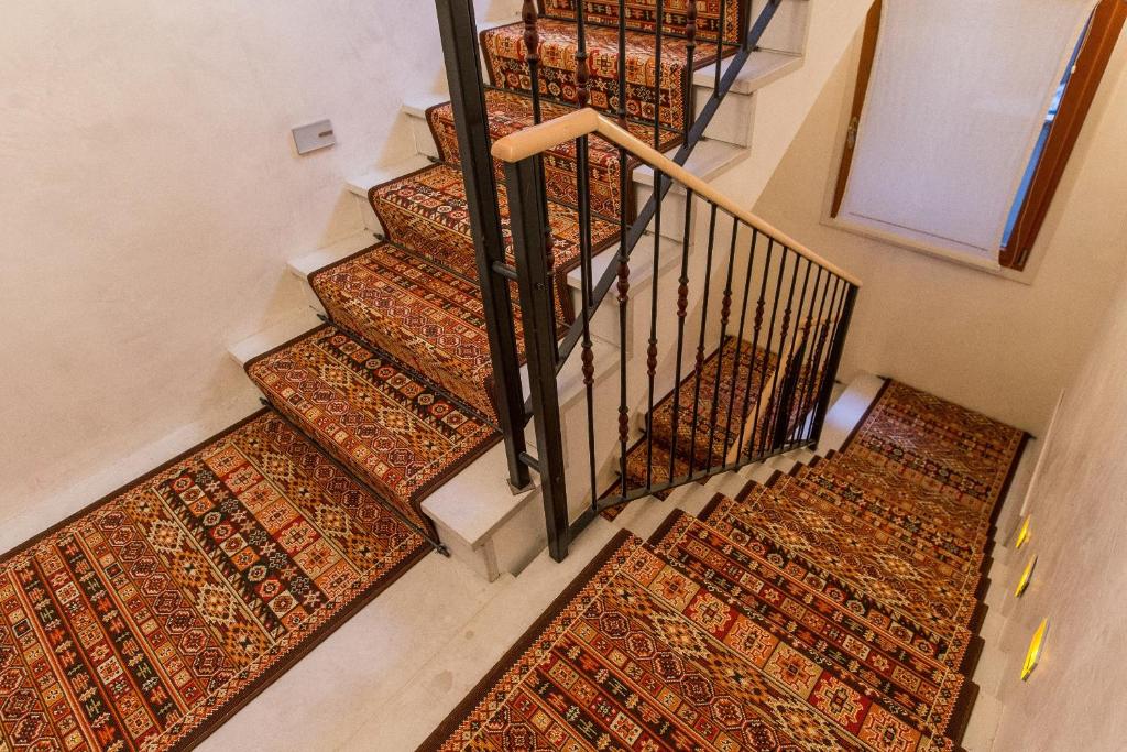 an overhead view of a set of stairs with rugs at Palazzo San Luca in Venice
