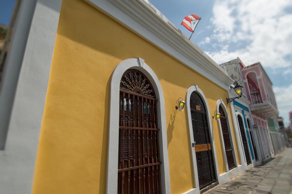 a yellow building with a kite flying in the sky at Casa Sol Bed and Breakfast in San Juan