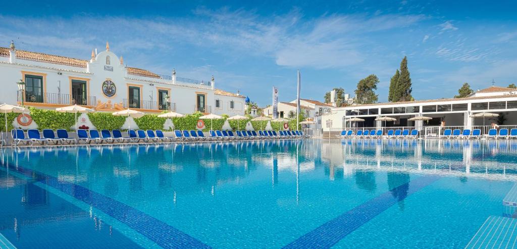 a large swimming pool in a large building at Globales Pueblo Andaluz in Marbella