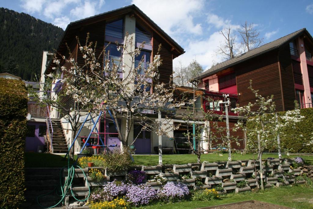 a house with a bunch of benches in front of it at B&B Gottardo in Airolo