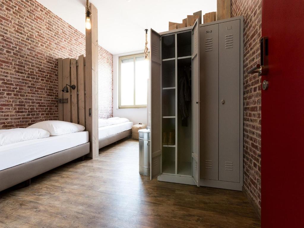 Postel nebo postele na pokoji v ubytování Heimathafen Hostel