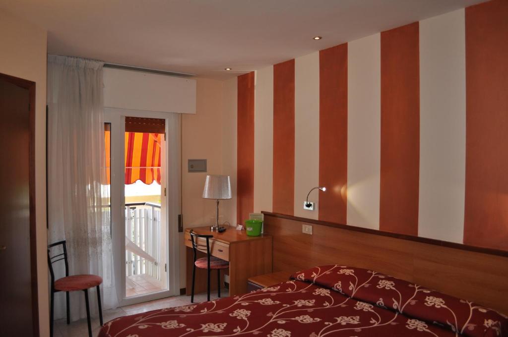 Postel nebo postele na pokoji v ubytování Hotel Righetto Fronte Mare